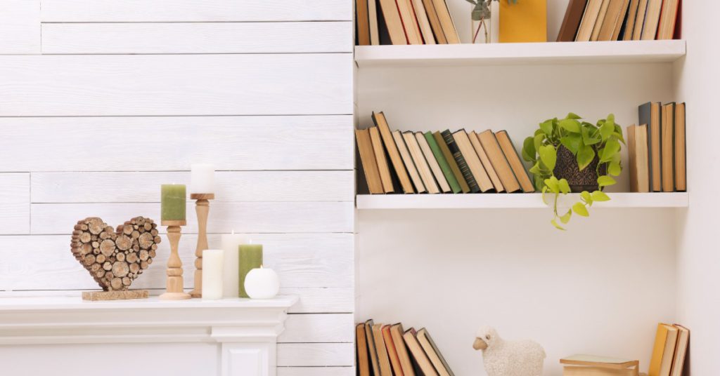 Books and decor pieces are arranged across indoor wall shelves, creating an organized display in a room.